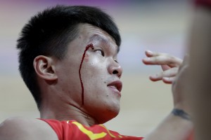 Blood runs down the face of China's Zhu Fangyu after he collided with another player during a preliminary men's basketball game against Australia at the 2012 Summer Olympics, Thursday, Aug. 2, 2012, in London. (AP Photo/Eric Gay)